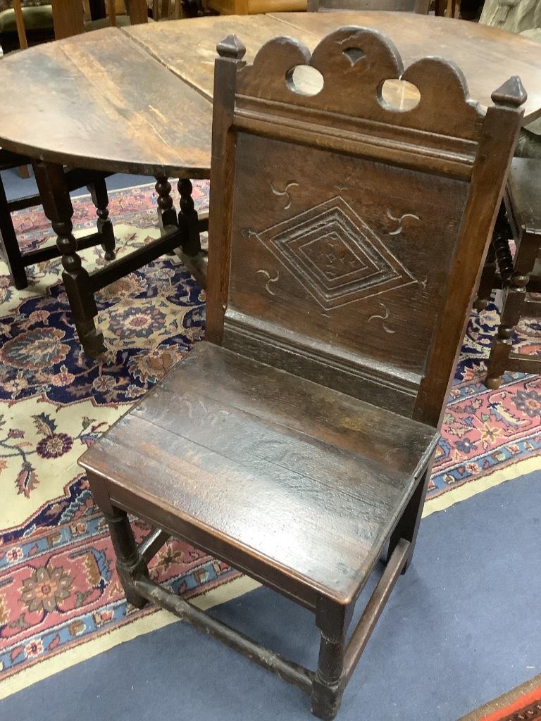 A 17th century oak back stool with lozenge carved decoration, width 48cm depth 49cm, height 99cm